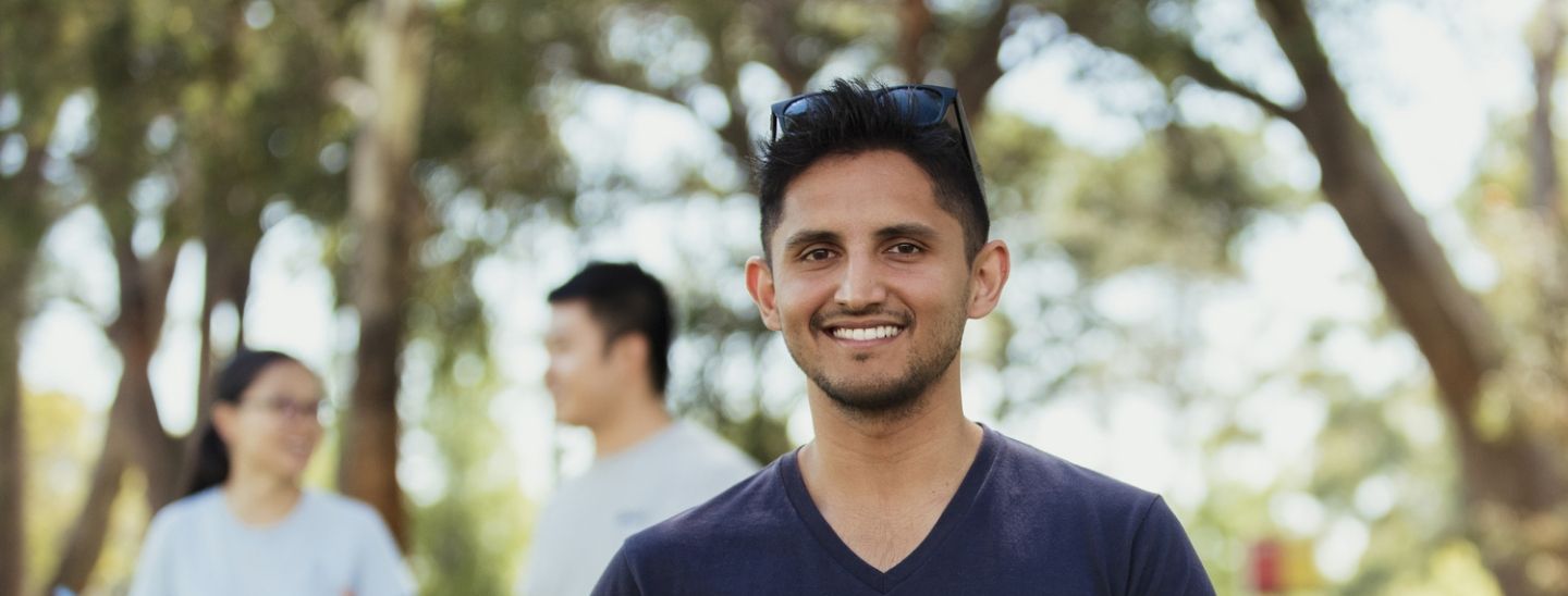 Man holding laptop outside