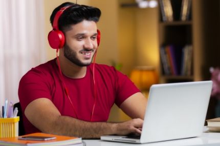 Man with headphones on laptop