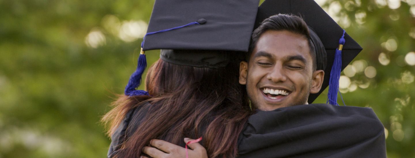 Students hugging graduation