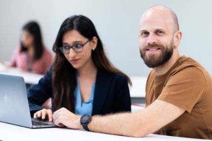 Students work on laptop in class