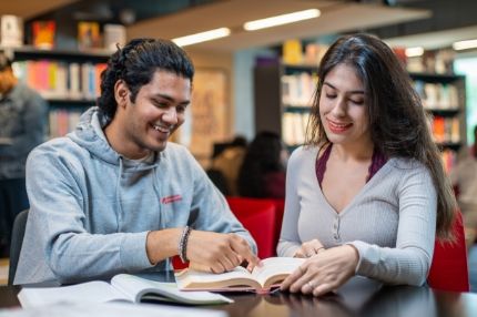 Two students having study session in library