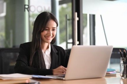 Woman happy working on laptop