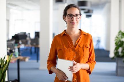 Woman holding paper in office
